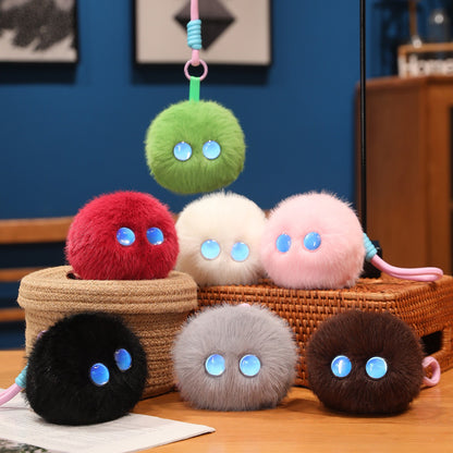 Colorful Pom-Pom plush companions photographed together; sold individually